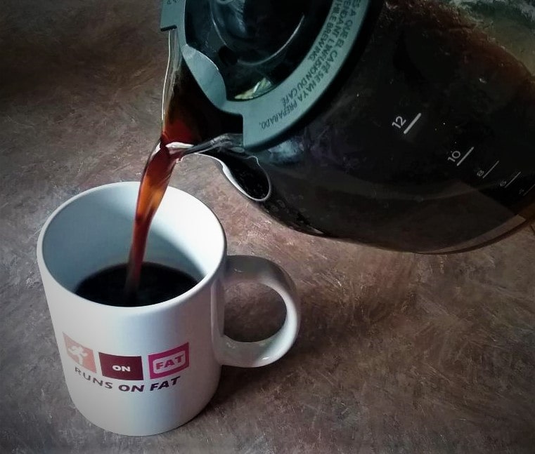 pouring coffee into runs on fat mug